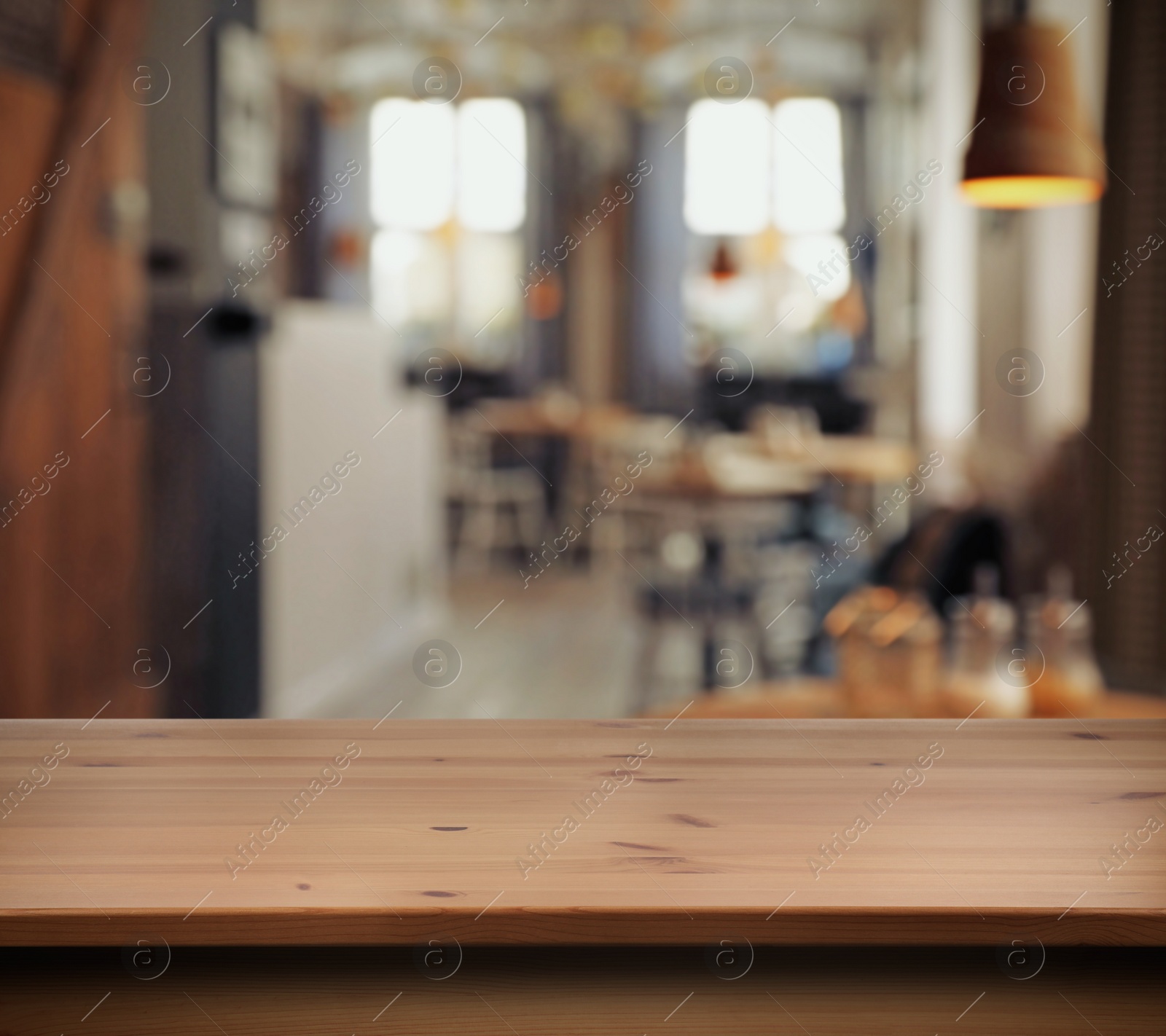 Image of Empty wooden surface and blurred view of cafe interior. Space for design