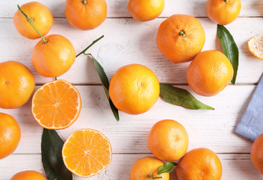 Fresh ripe tangerines on white wooden table, flat lay