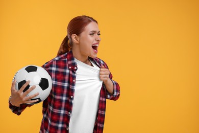 Emotional fan holding football ball on yellow background, space for text