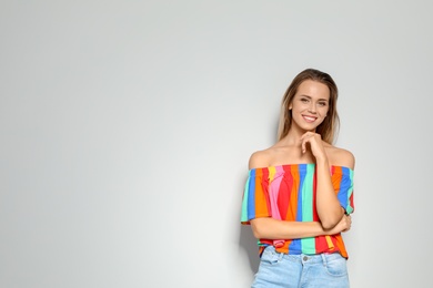 Portrait of beautiful woman on light background