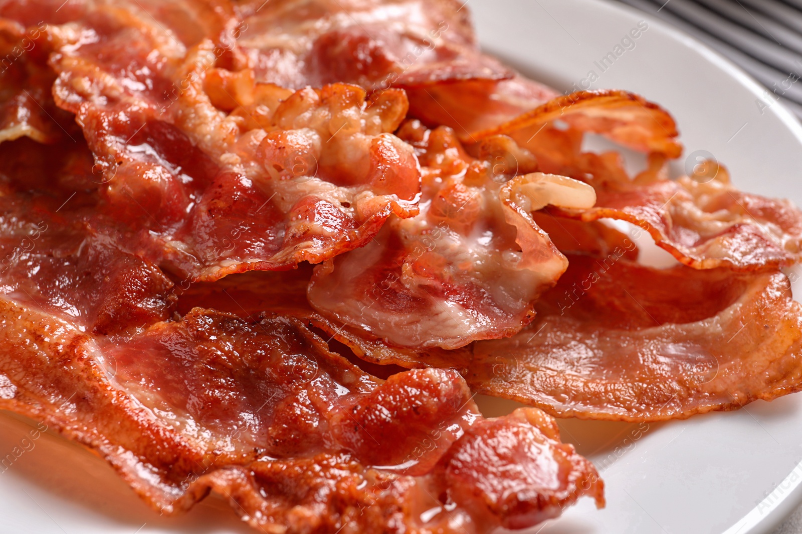 Photo of Plate with fried bacon, closeup