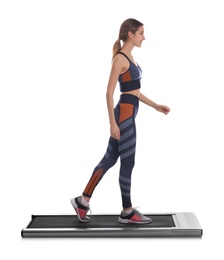 Photo of Sporty woman using walking treadmill on white background