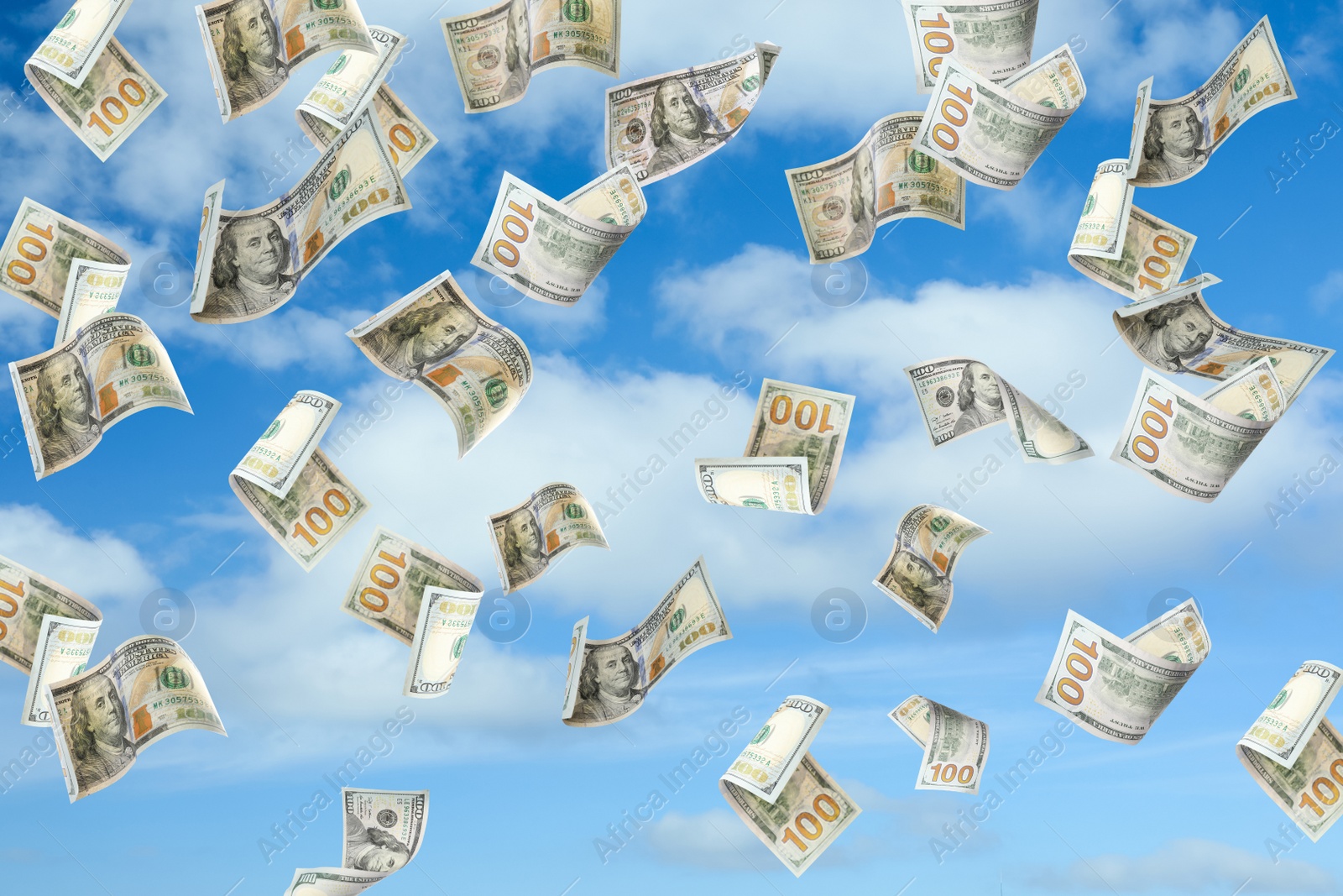 Image of Falling American dollars and blue sky on background. Money rain