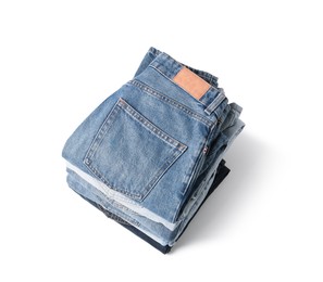 Image of Stack of different folded jeans isolated on white