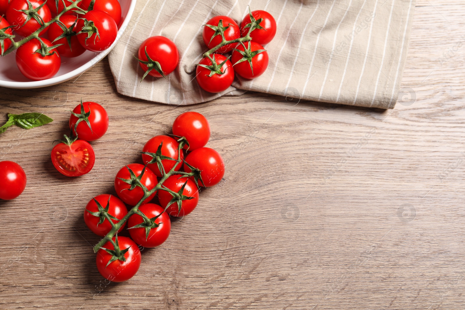 Photo of Flat lay composition with cherry tomatoes on wooden background. Space for text