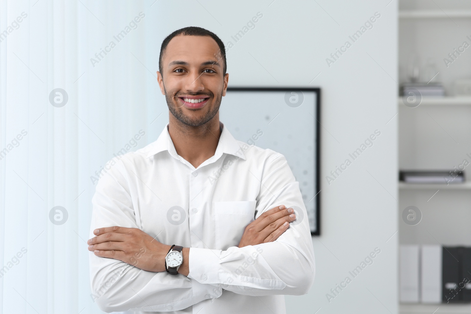 Photo of Portrait of handsome young man in white shirt indoors