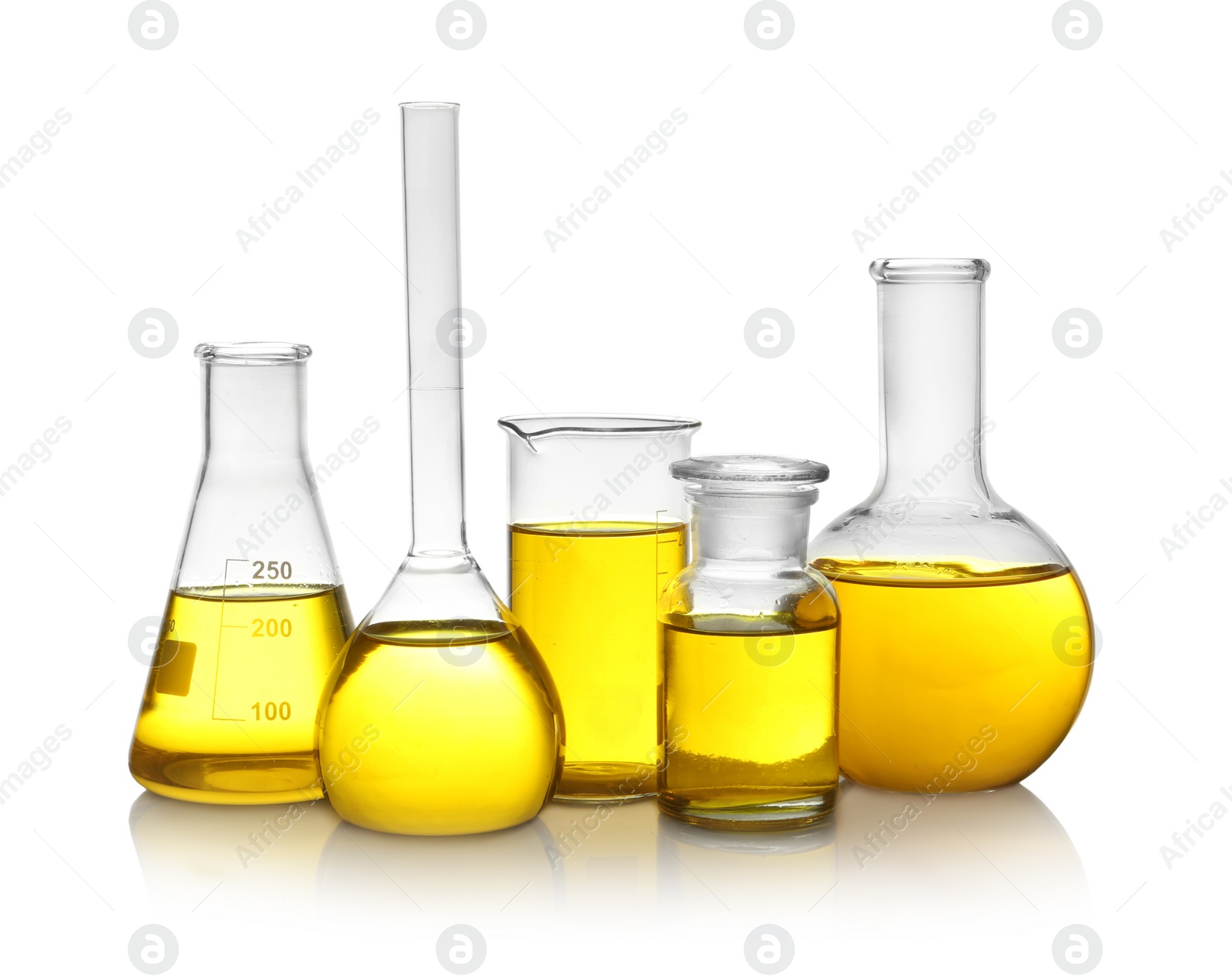 Photo of Laboratory glassware with yellow liquid on white background