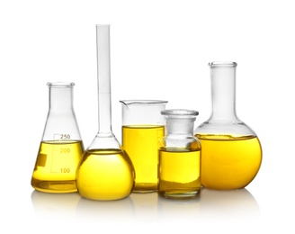 Photo of Laboratory glassware with yellow liquid on white background