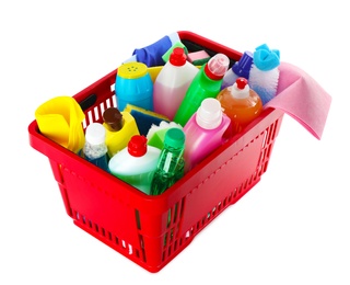 Photo of Shopping basket with different detergents and rag on white background