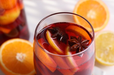 Glass of aromatic punch drink on table, closeup