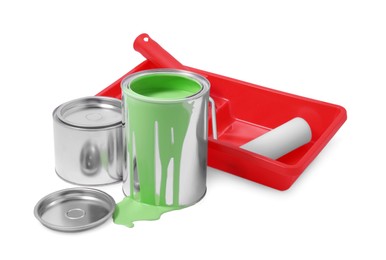 Photo of Cans of paint, roller and tray isolated on white