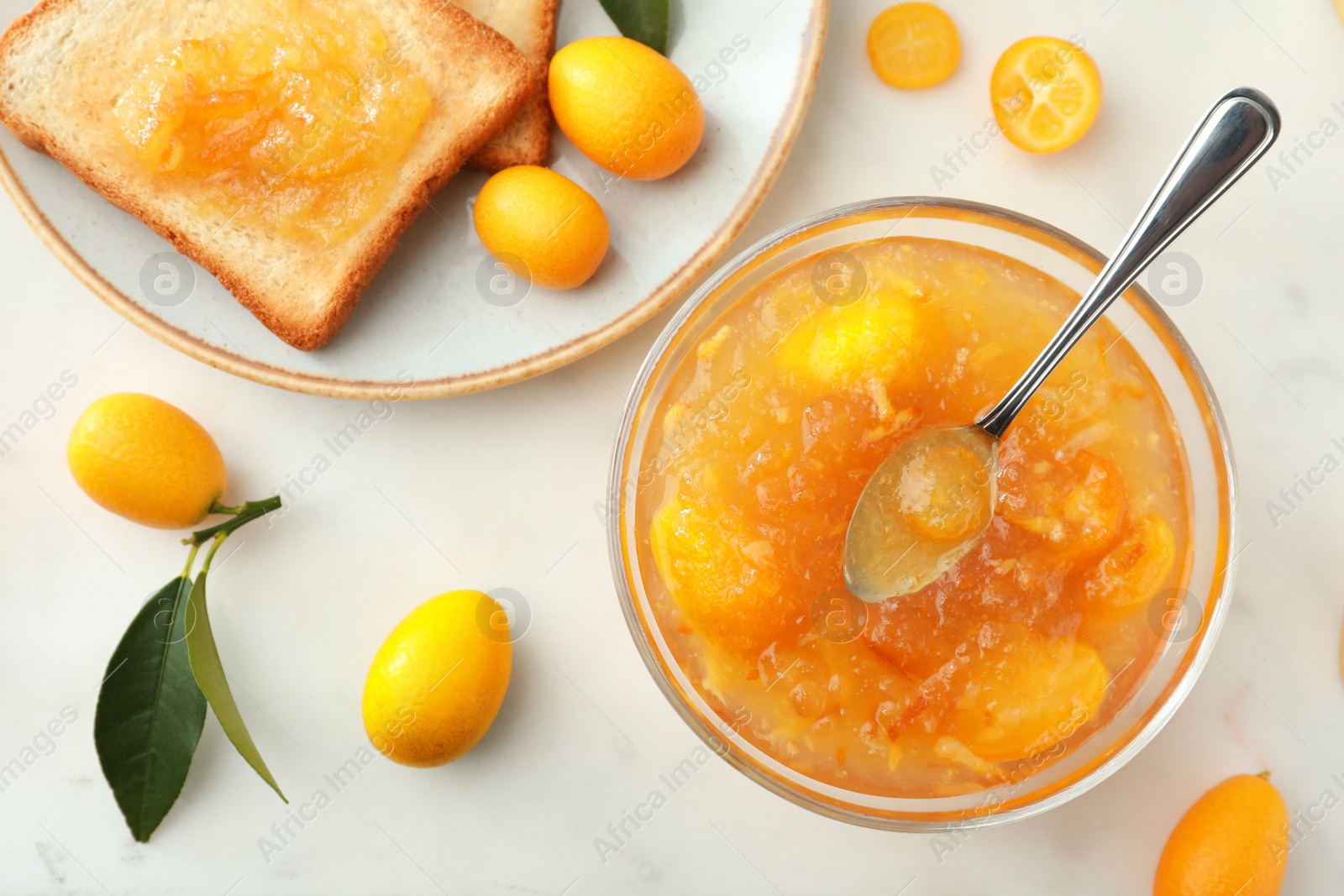 Photo of Delicious kumquat jam, fresh fruits and sandwich on white table, flat lay
