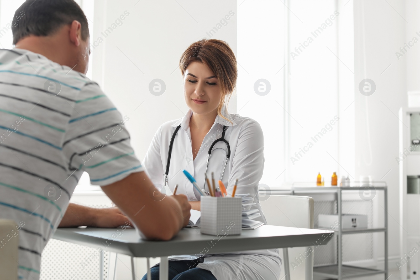 Photo of Patient having appointment with doctor in hospital