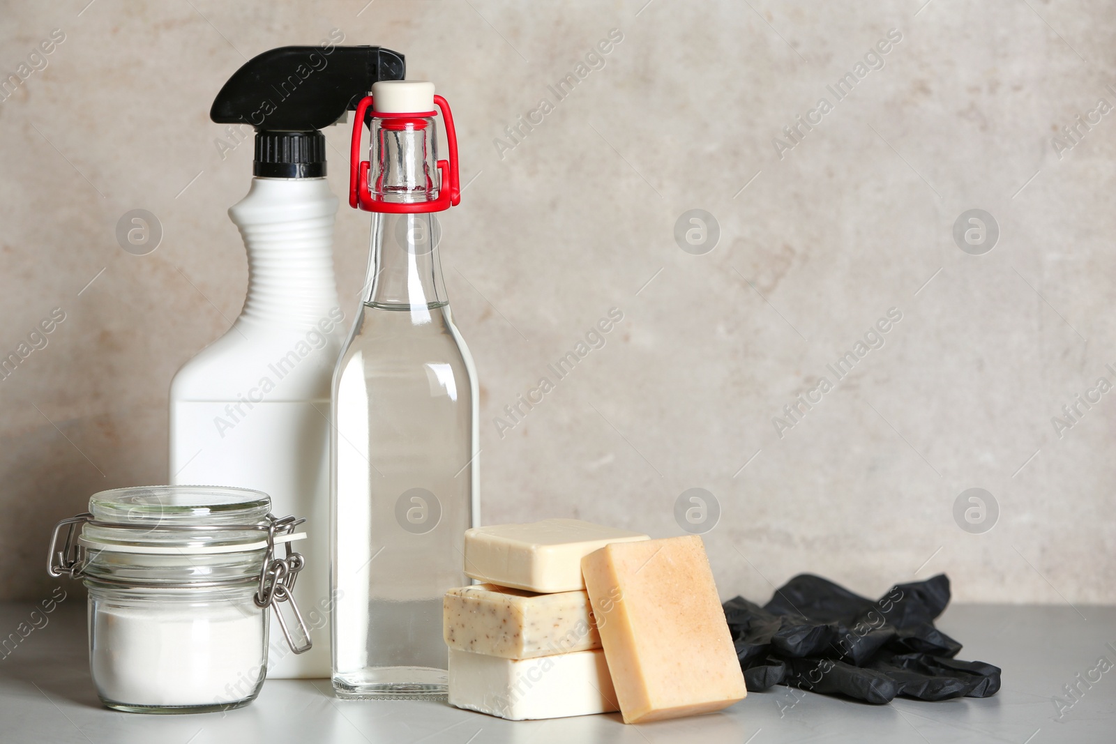 Photo of Composition with vinegar and cleaning supplies on table. Space for text