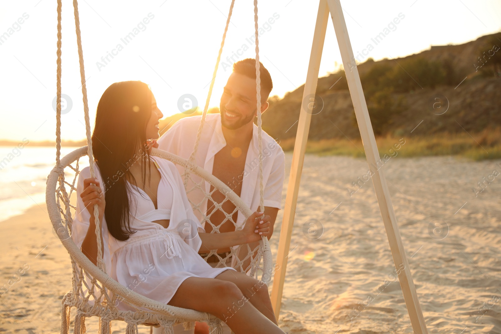 Photo of Happy young couple on beach at sunset