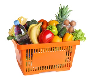 Shopping basket with grocery products on white background