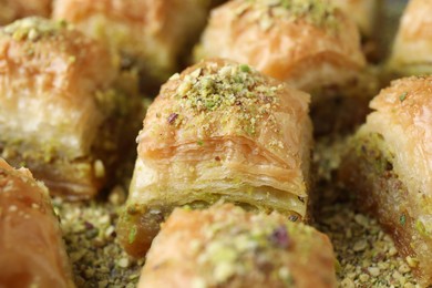 Delicious fresh baklava with chopped nuts on table, closeup. Eastern sweets