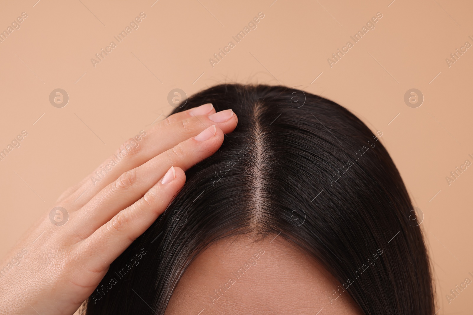 Photo of Woman with healthy hair on beige background, closeup