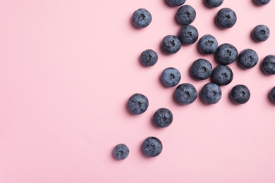 Photo of Flat lay composition with tasty blueberry and space for text on color background