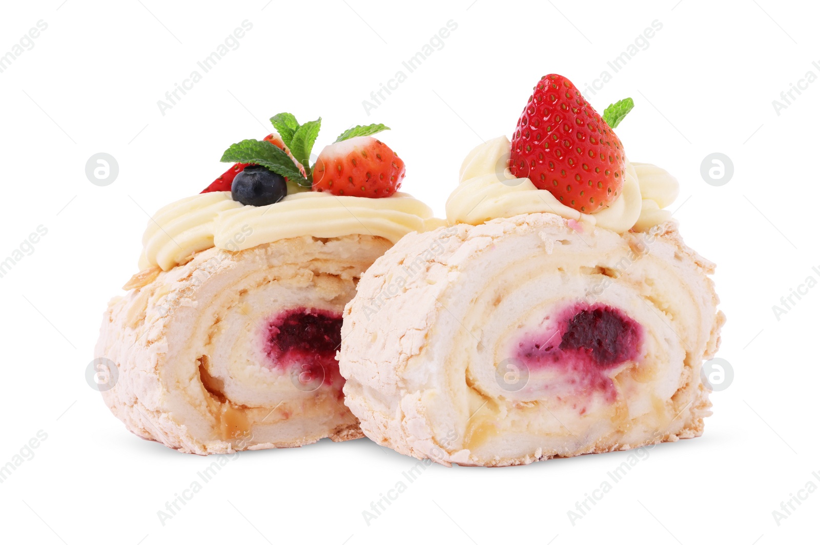 Photo of Slices of tasty meringue roll with jam, berries and mint leaves isolated on white