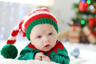 Photo of Cute baby in Christmas costume at home