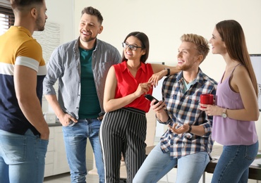 Photo of Group of happy people talking in office