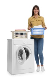 Beautiful woman with laundry basket near washing machine on white background