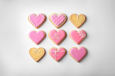 Decorated heart shaped cookies on white background, top view. Valentine's day treats