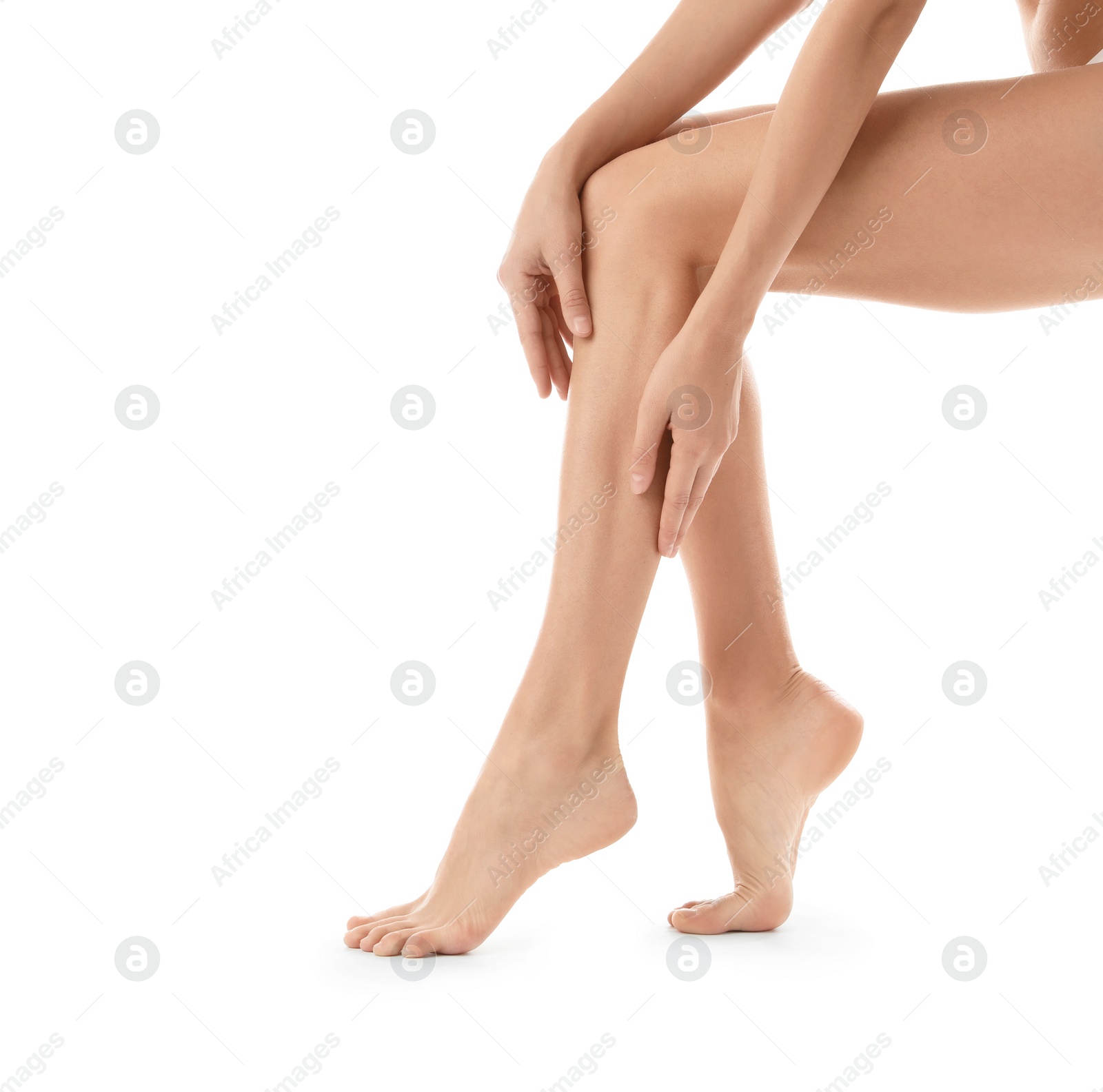 Photo of Young woman with beautiful long legs on white background, closeup