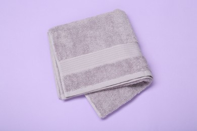Photo of Terry towel on violet background, top view