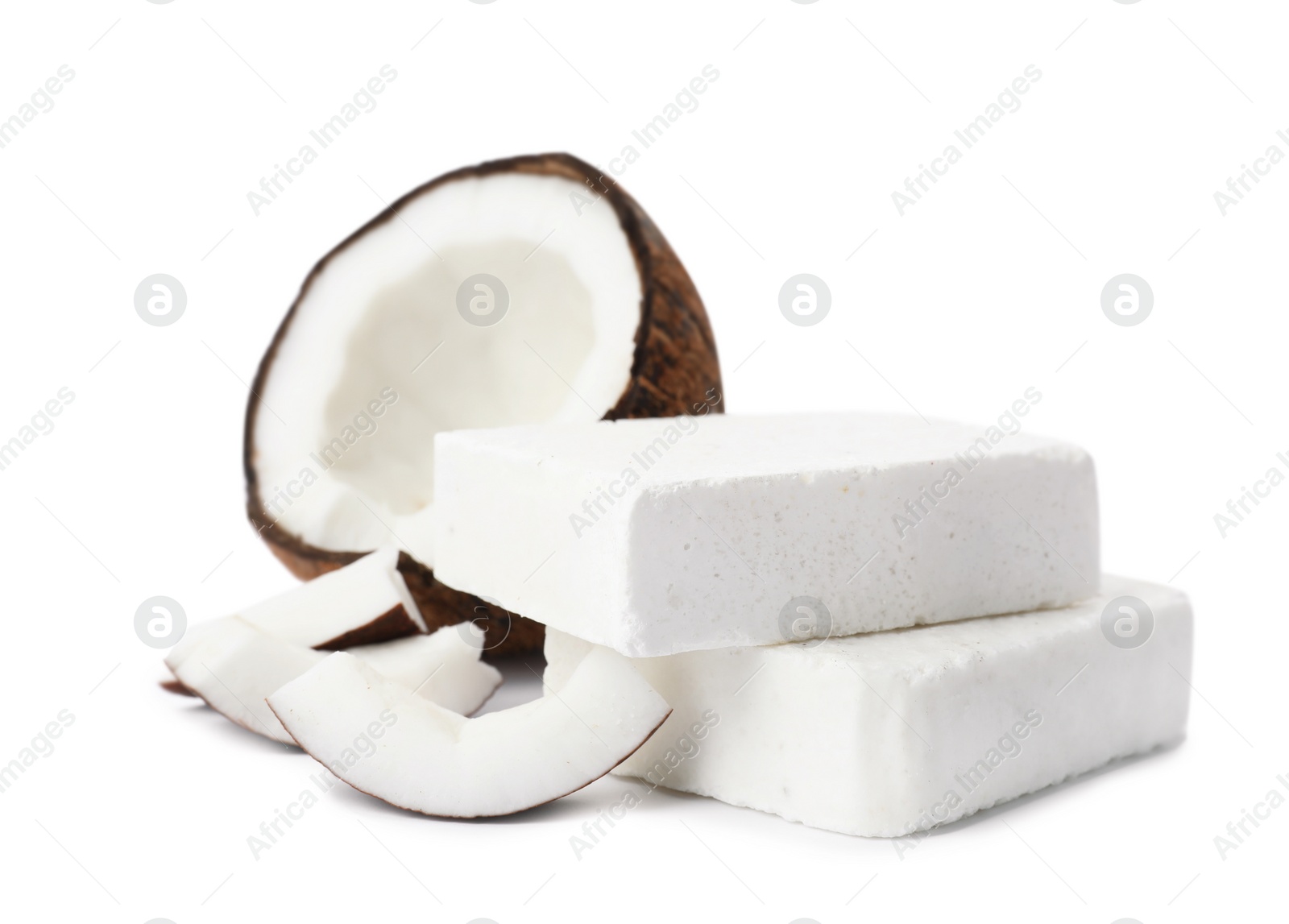 Photo of Handmade soap bars and coconut on white background