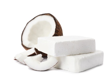 Handmade soap bars and coconut on white background