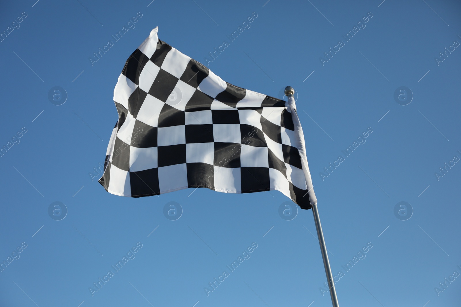 Photo of Checkered finish flag on light blue background