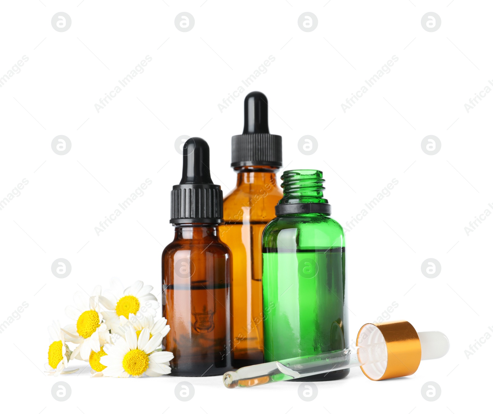 Photo of Bottles of herbal essential oils, chamomile flowers and pipette isolated on white