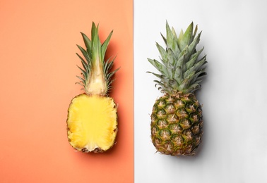 Photo of Flat lay composition with cut and fresh juicy pineapples on color background