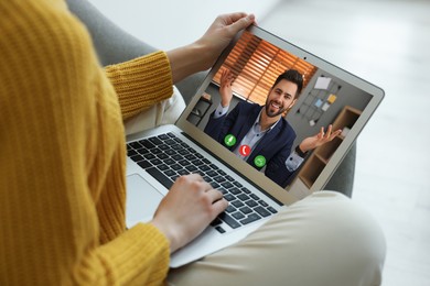Image of Woman talking with handsome man using video chat on laptop indoors, closeup. Online dating