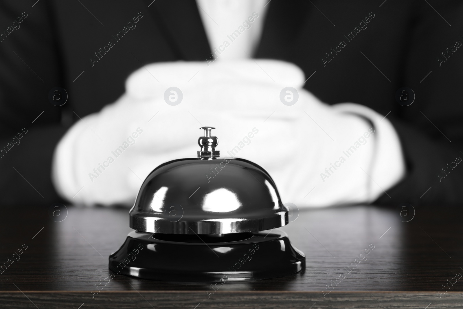 Photo of Butler at desk with service bell, closeup view