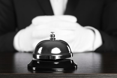 Butler at desk with service bell, closeup view