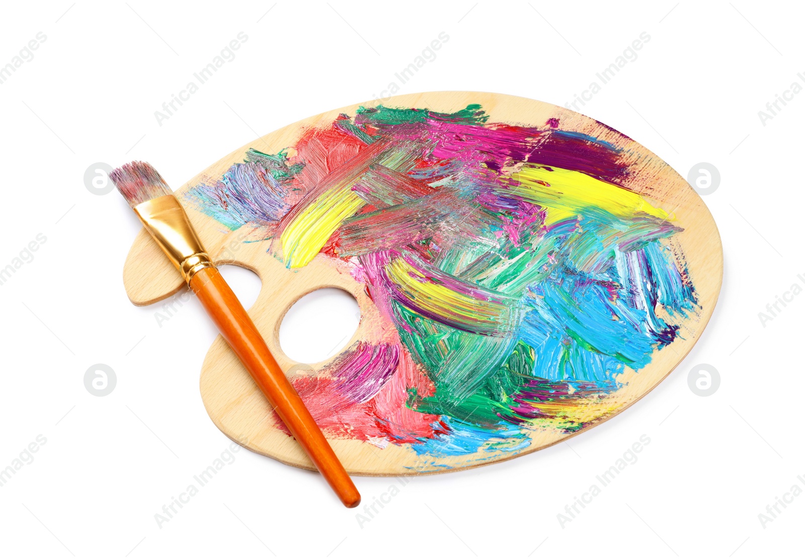 Photo of Wooden artist's palette with mixed paints and brush isolated on white