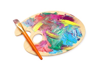 Wooden artist's palette with mixed paints and brush isolated on white