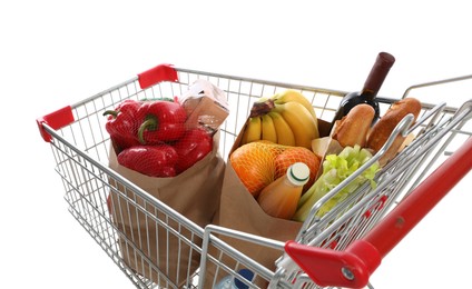 Shopping cart full of groceries on white background