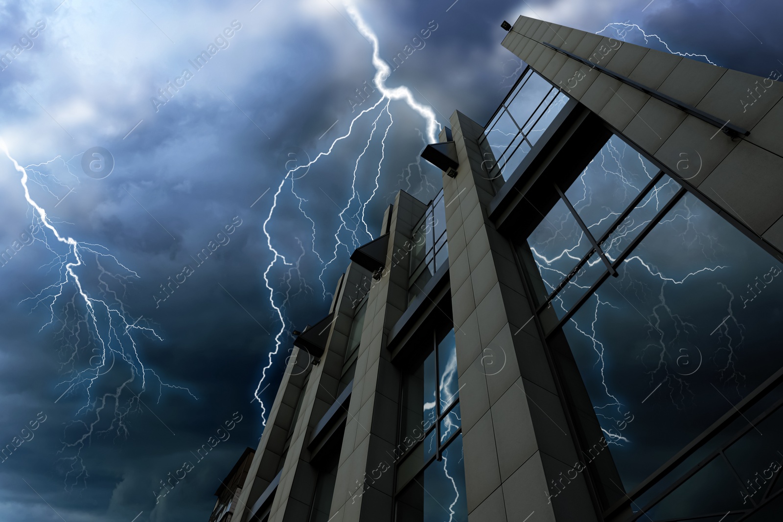 Image of Dark cloudy sky with lightning over building. Stormy weather