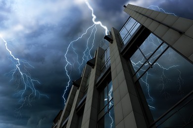 Dark cloudy sky with lightning over building. Stormy weather