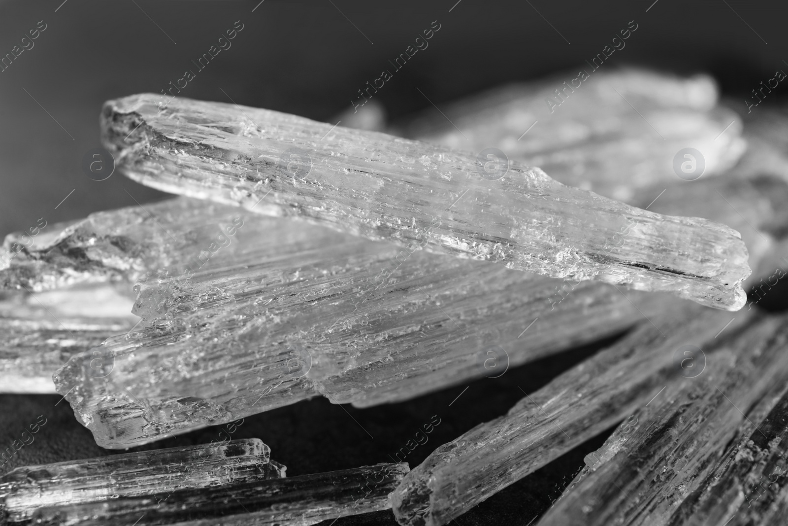 Photo of Menthol crystals on grey background, closeup view