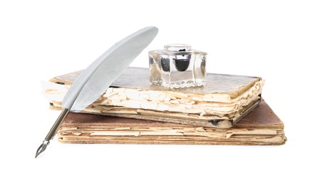 Photo of Feather pen, inkwell and old books on white background