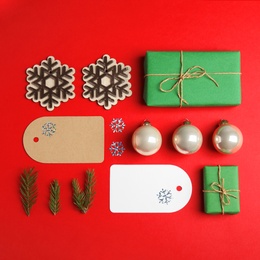 Flat lay composition with Christmas decor on red background