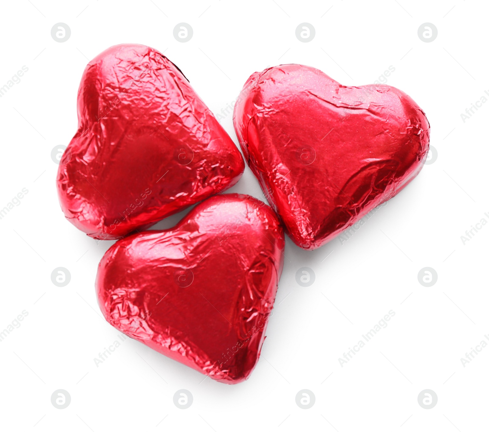 Photo of Heart shaped chocolate candies in red foil on white background, top view