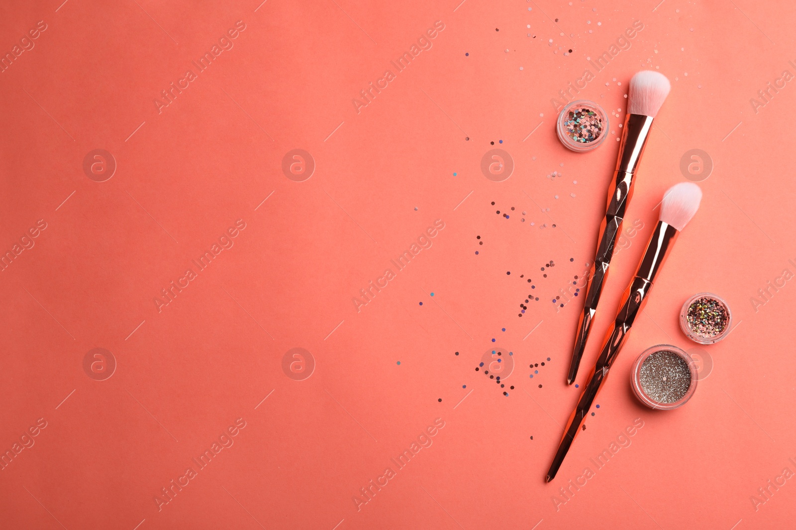 Photo of Flat lay composition with beauty accessories and space for text on coral background