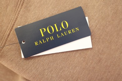 Leiden, Netherlands - December 6, 2023: Polo Ralph Lauren clothing tags on brown garment, top view