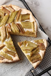 Photo of Freshly baked rhubarb pie on white marble table, top view